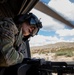 U.S. Army Door Gunner scans terrain for landing while on a CH-47F Chinook