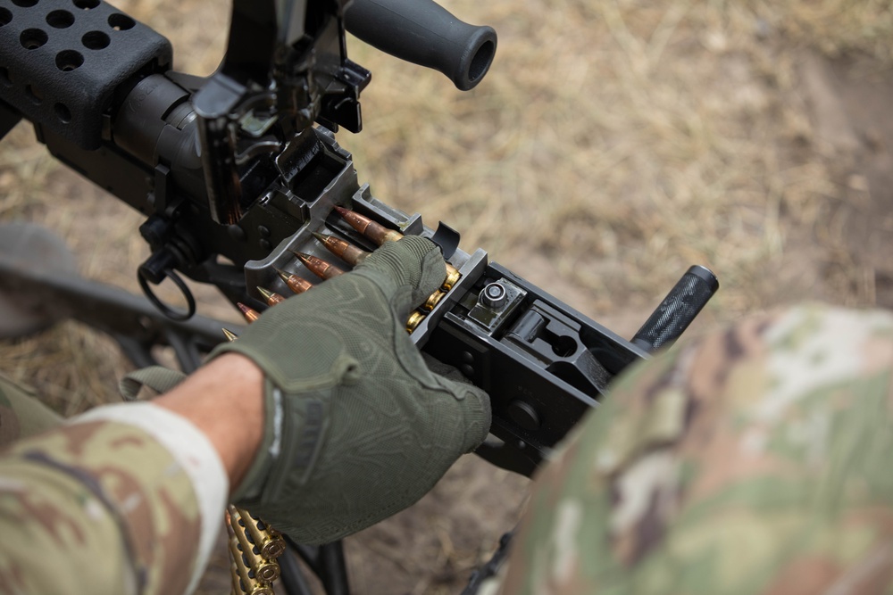 All Army Reserve Best Squad competitors work together as they qualify on the M249