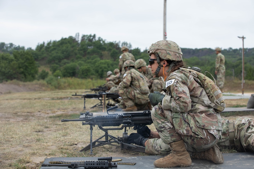 Sgt. Amanda Edgerton guides her teammate during the M249 qualification