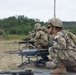 Sgt. Amanda Edgerton guides her teammate during the M249 qualification