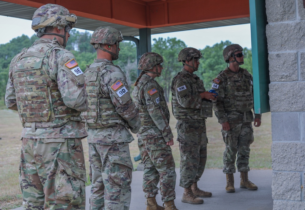 U.S. Army Reserve Best Squad competitors line up to receive M781 training grenade launcher grenades.