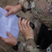 A U.S. Army Reserve Best Squad competitor speaks into a hand-held radio transmitter