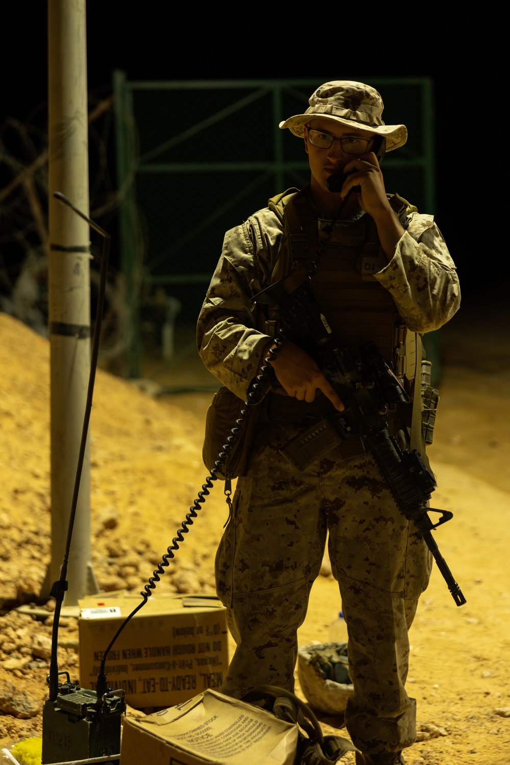 U.S. Marines, Army service members post security at an entry control point.