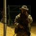 U.S. Marines, Army service members post security at an entry control point.