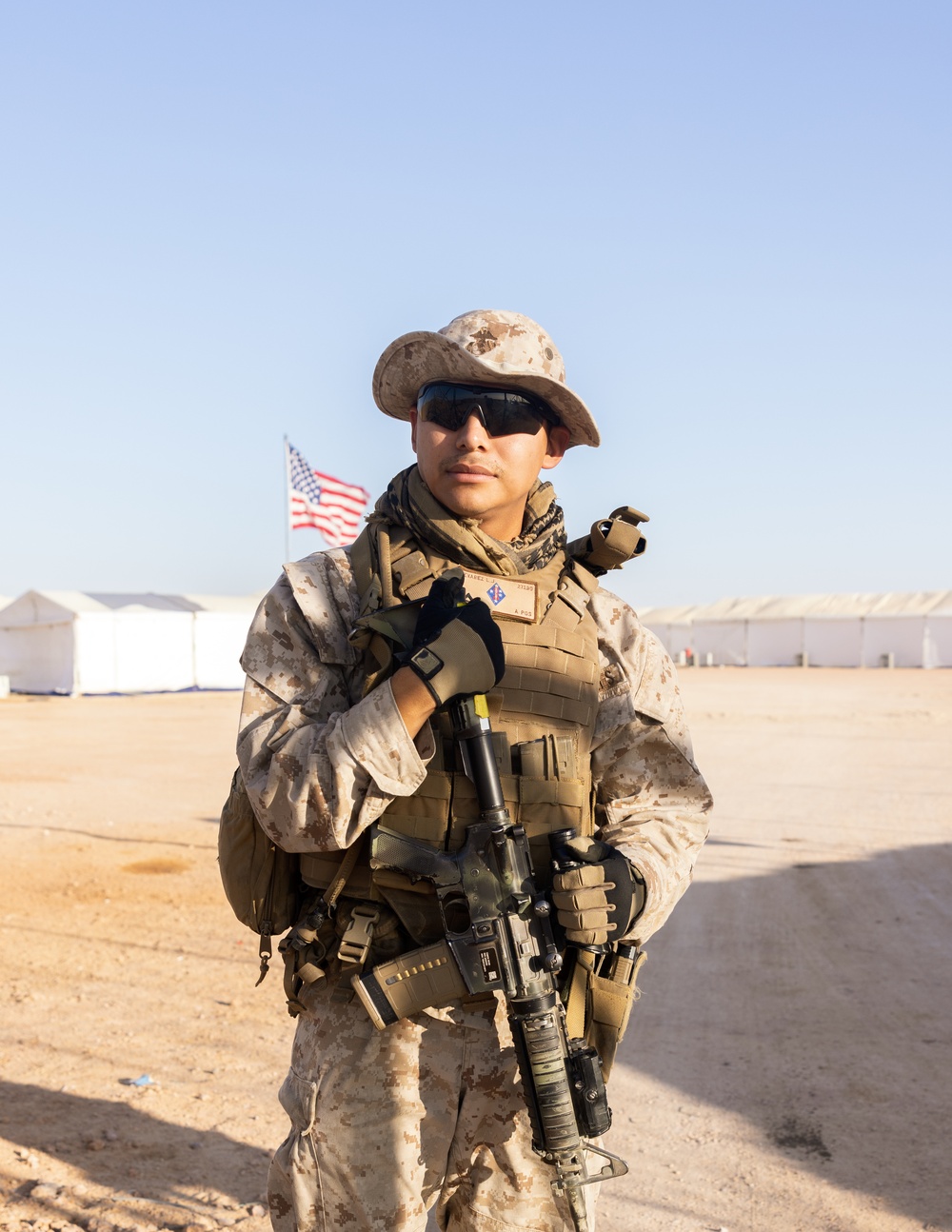 U.S. Marines, Army service members post security at an entry control point.