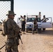 U.S. Marines, Army service members post security at an entry control point.