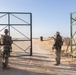 U.S. Marines, Army service members post security at an entry control point.