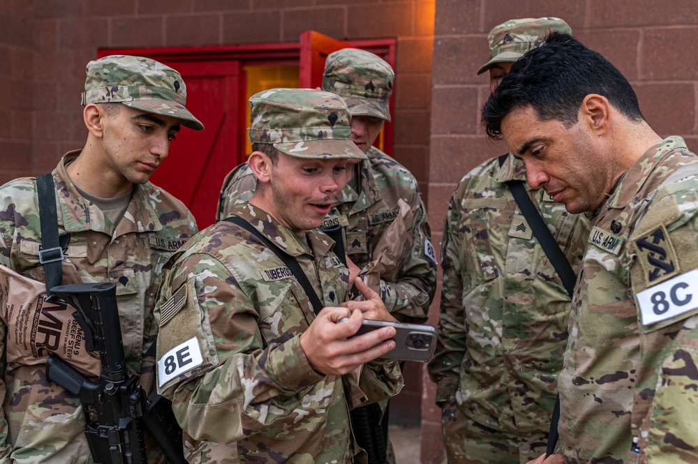 U.S. Army Reserve Best Squad competitors take a break to look at photos and videos