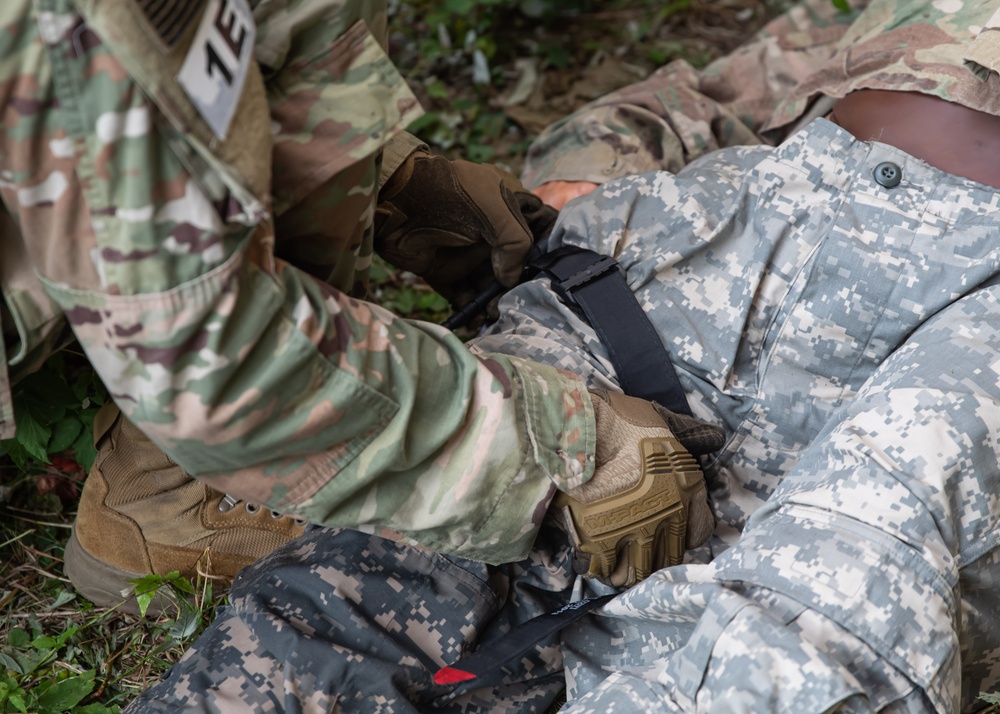 Army Spc. Nelson Medina applies a tourniquet to a simulated casualty