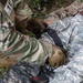 Army Spc. Nelson Medina applies a tourniquet to a simulated casualty