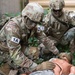 Army  Sgt. 1st Class Juan Torres applies medical assistance to a simulated casualty