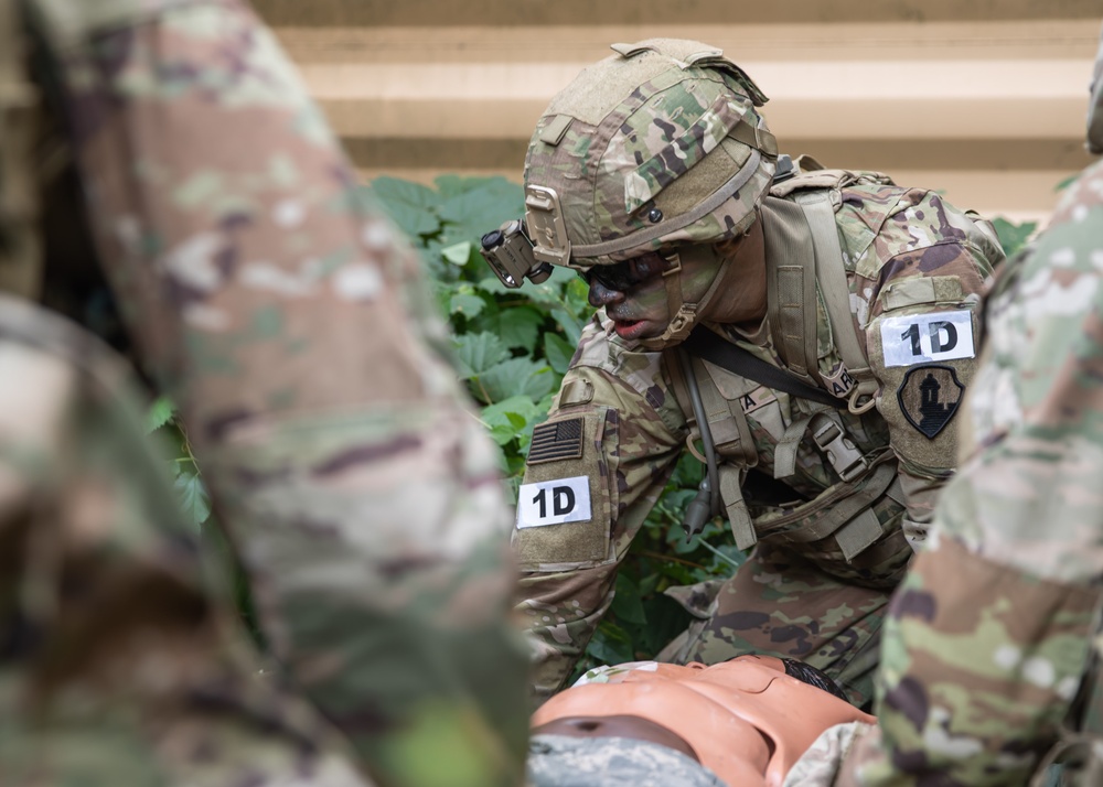 Army Spc. Elvin Rivera applies medical assistance to a simulated casualty