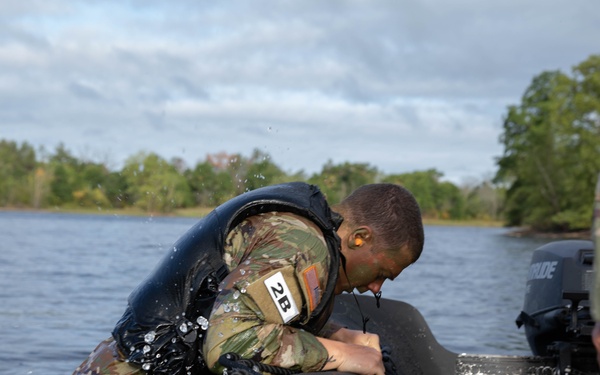 Spc. Nathaniel Wells pulls himself into a zodiac boat