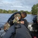 Spc. Nathaniel Wells pulls himself into a zodiac boat