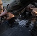 Army Reserve Best Squad competitors help their teammates into the zodiac boat