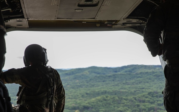 Army Reserve Best Squad competitors ride in a CH-47 Chinook