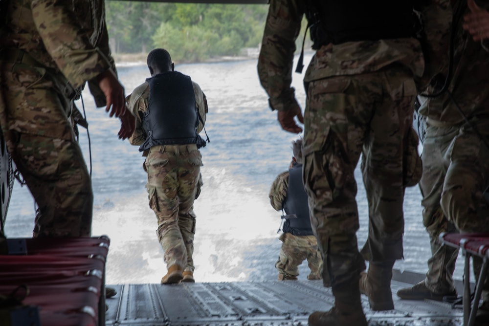 Army Reserve Best Squad competitors jump into Big Sandy Lake