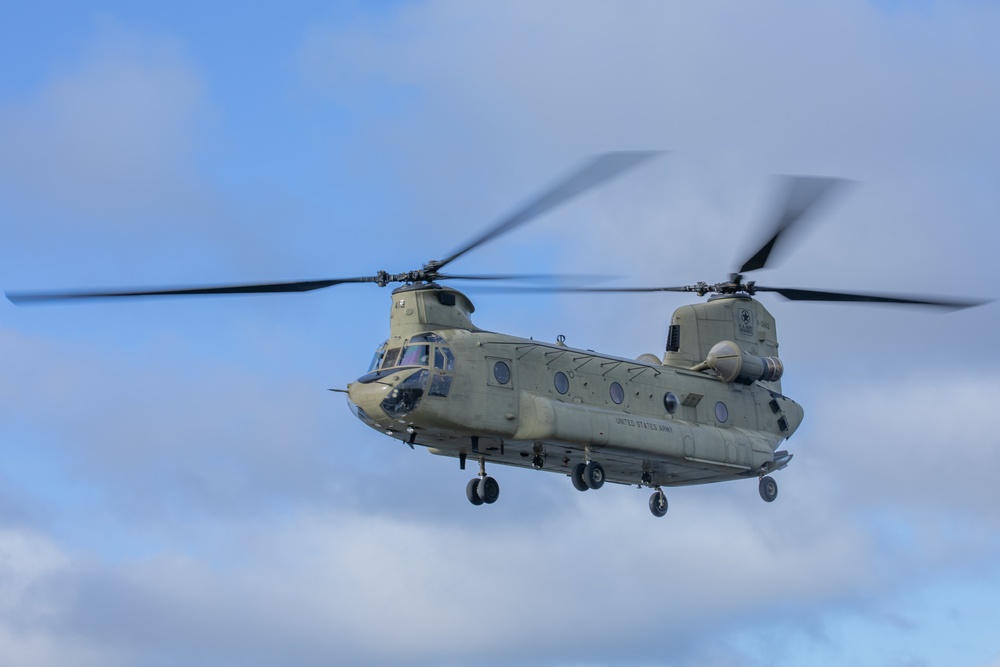 A CH-47 Chinook flies overhead