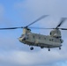 A CH-47 Chinook flies overhead