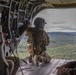 A U.S. Army reserve soldier kneels on the loading ramp of a CH-47 Chinook