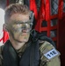 Private 1st Class Kaleb Brown watches out of the back of a Boeing CH-47 Chinook