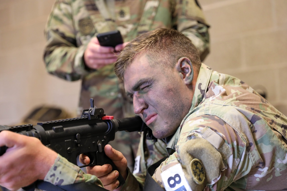 Sgt. Timothy Coggins aims an M4 equipped with a MantisX shooting analysis system