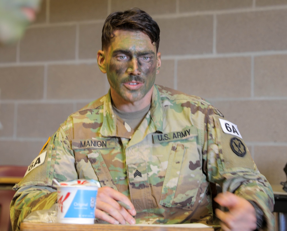 Sgt. Thomas Manion speaks with his squad during essay preparation