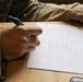 A U.S. Army Best Squad Competitor writes during the essay preparation event