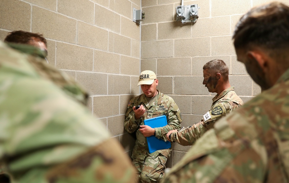 An instructor times U.S. Army Reserve Best Squad Competitors during the Box O' Guns event