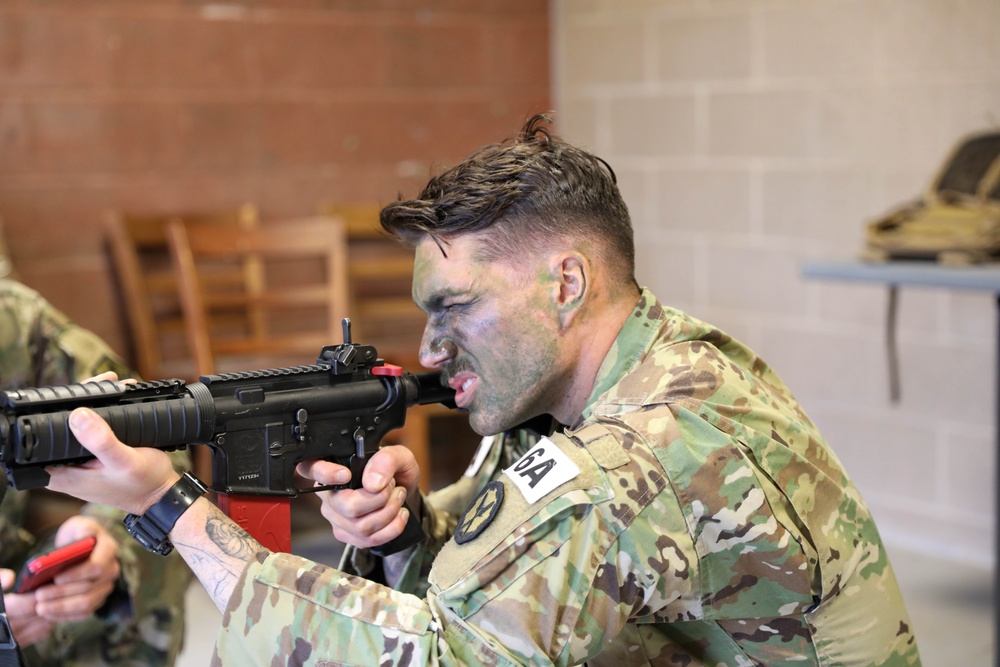 Sgt. Thomas Manion aims an M4 equipped with a MantisX shooting analysis system