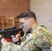 Sgt. Thomas Manion aims an M4 equipped with a MantisX shooting analysis system