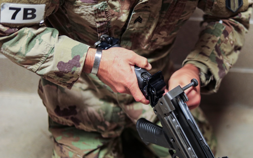 Sgt. Alejandro N. Thaureauxlago puts together an M249