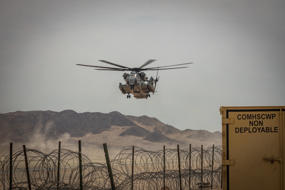 U.S. Navy MQ-8C Fire Scout first time ground refueling by U.S. Marine Corps CH-53E Super Stallion