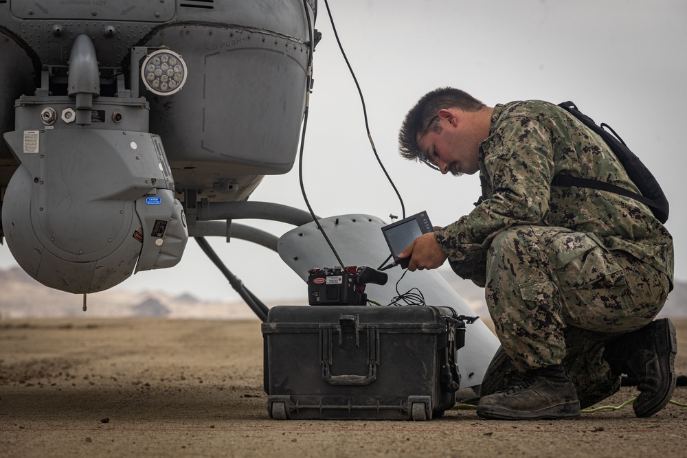 U.S. Navy MQ-8C Fire Scout first time ground refueling by U.S. Marine Corps CH-53E Super Stallion