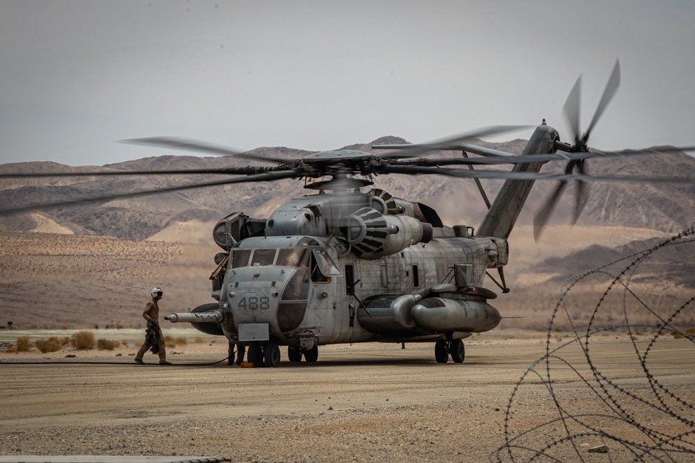 U.S. Navy MQ-8C Fire Scout first time ground refueling by U.S. Marine Corps CH-53E Super Stallion