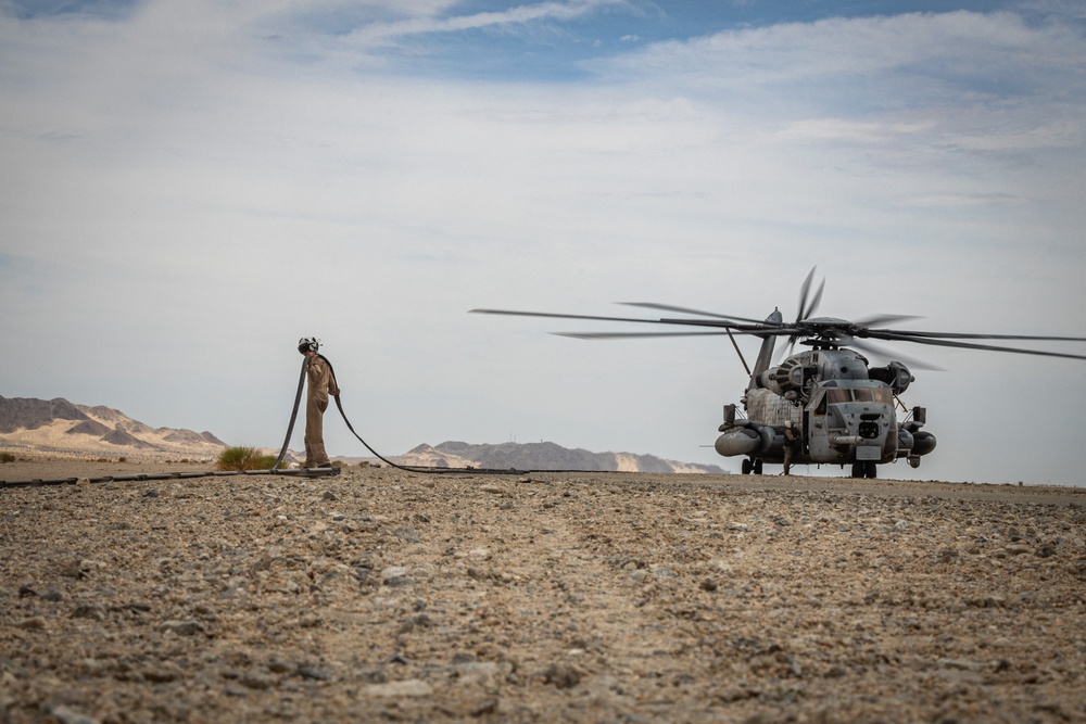 U.S. Navy MQ-8C Fire Scout first time ground refueling by U.S. Marine Corps CH-53E Super Stallion