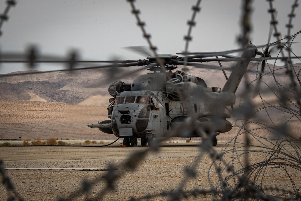 U.S. Navy MQ-8C Fire Scout first time ground refueling by U.S. Marine Corps CH-53E Super Stallion