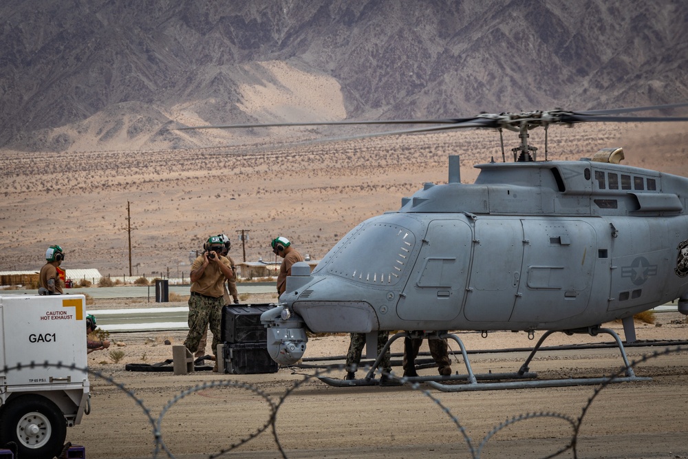 U.S. Navy MQ-8C Fire Scout first time ground refueling by U.S. Marine Corps CH-53E Super Stallion