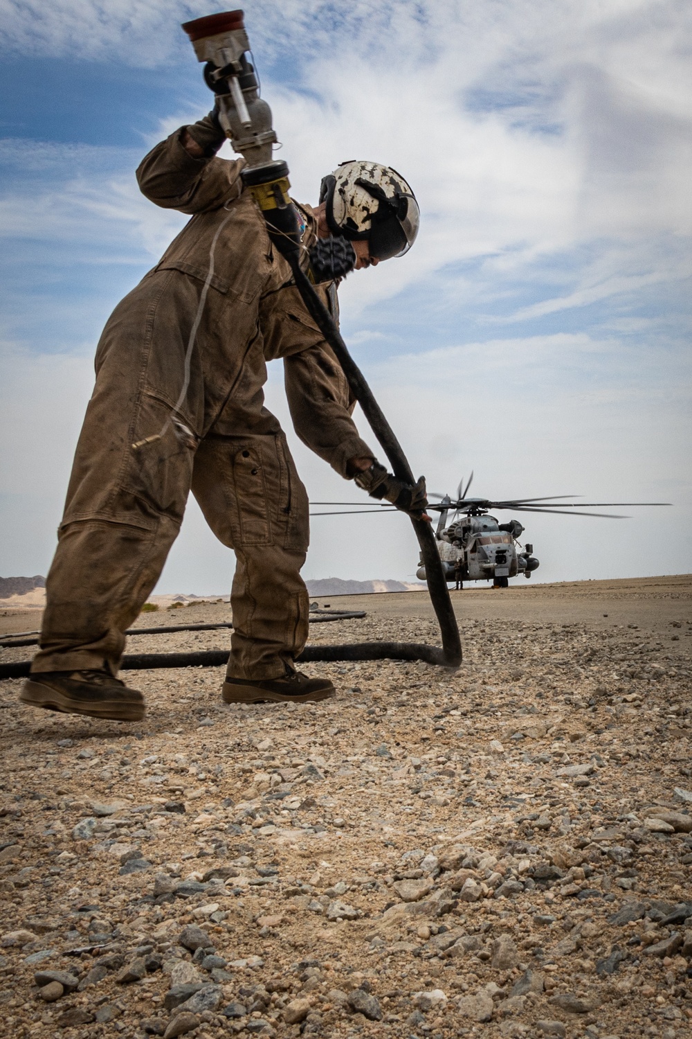 U.S. Navy MQ-8C Fire Scout first time ground refueling by U.S. Marine Corps CH-53E Super Stallion