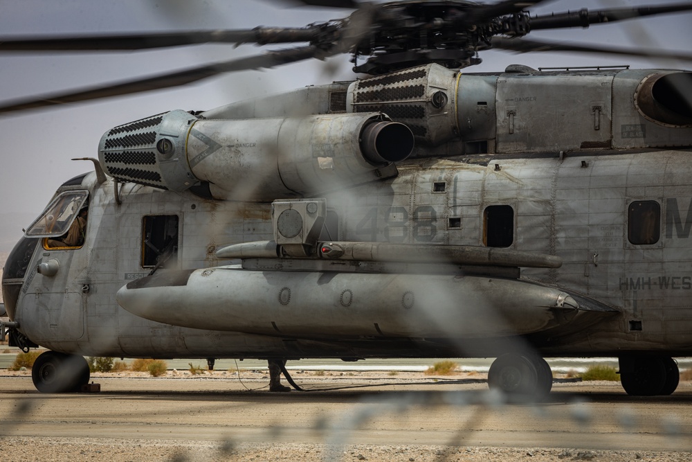 U.S. Navy MQ-8C Fire Scout first time ground refueling by U.S. Marine Corps CH-53E Super Stallion