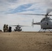 A CH-53E Super Stallion first time ground refueling a U.S. Navy MQ-8C Fire Scout unmanned helicopter