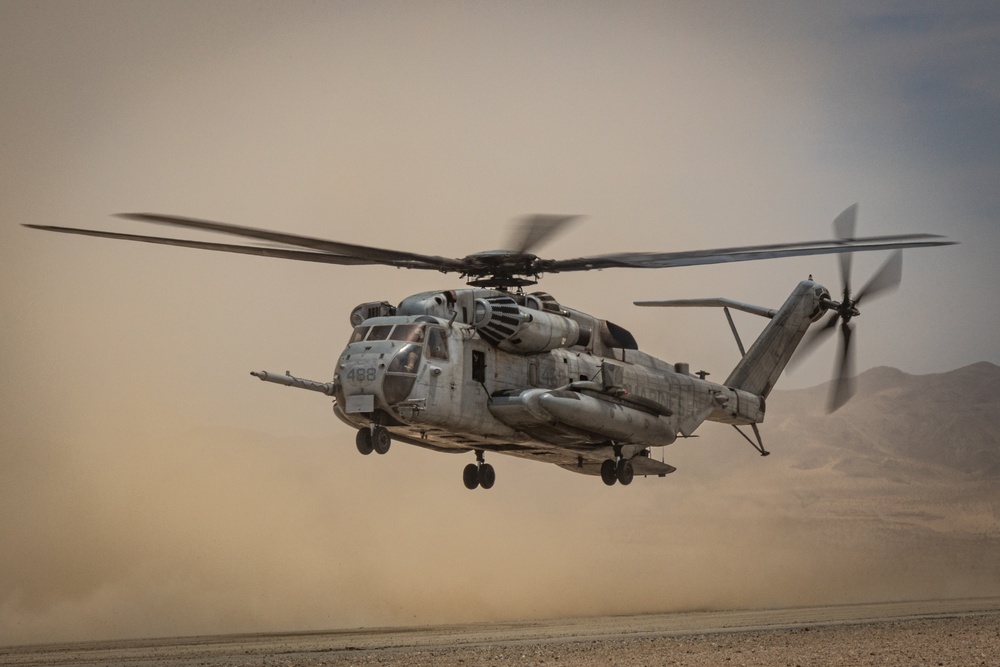 U.S. Navy MQ-8C Fire Scout first time ground refueling by U.S. Marine Corps CH-53E Super Stallion