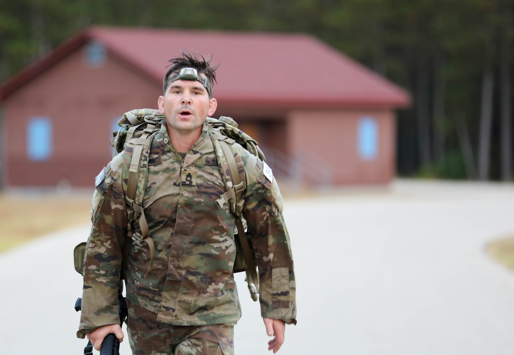 Sgt. 1st Class Culter Holland nears the finish line of a 12-mile ruck march