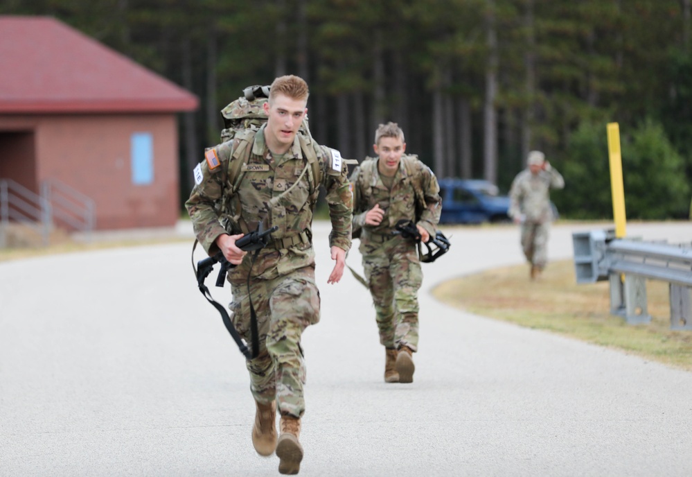 Pfc. Kaleb Brown and Spc. Justin Helper head to the finish line of a 12-mile ruck march