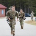 Pfc. Kaleb Brown and Spc. Justin Helper head to the finish line of a 12-mile ruck march