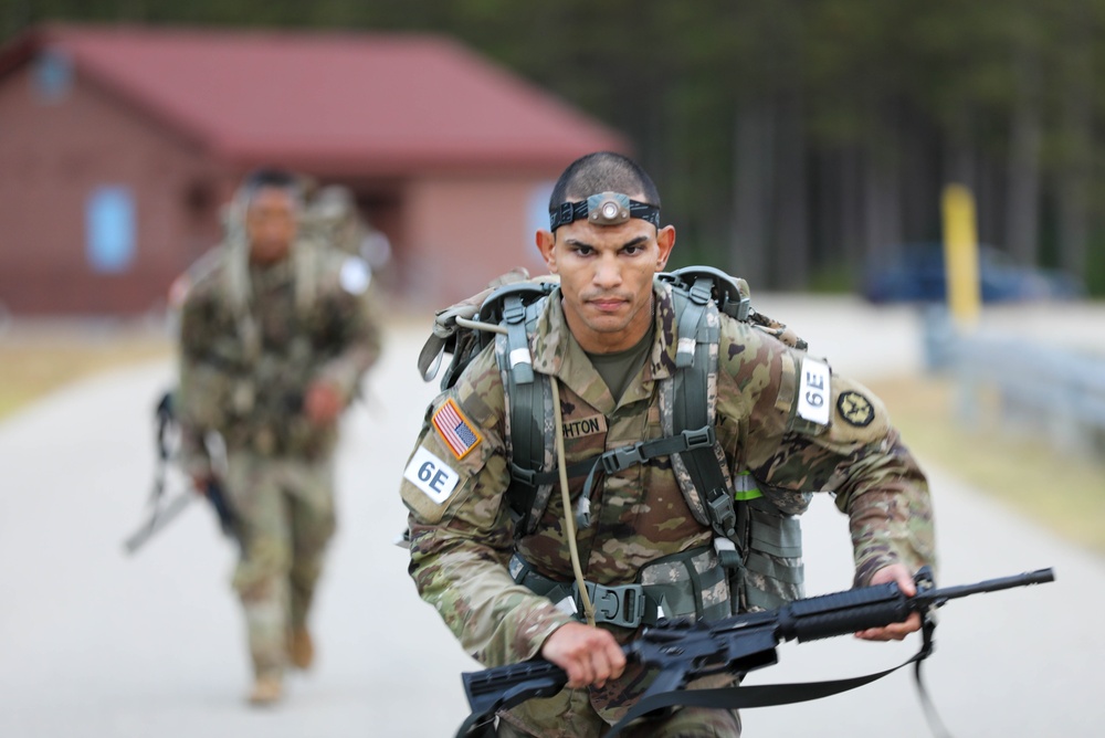 Spc. Robert Broughton heads toward the finish line of a 12-mile ruck march