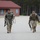 Spc. Christian Jaen-Morales (left) and Sgt. 1st Class Christopher McBride (right) head toward the finish of a 12 mile ruck march