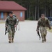 Spc. Christian Jaen-Morales (left) and Sgt. 1st Class Christopher McBride (right) head toward the finish of a 12 mile ruck march