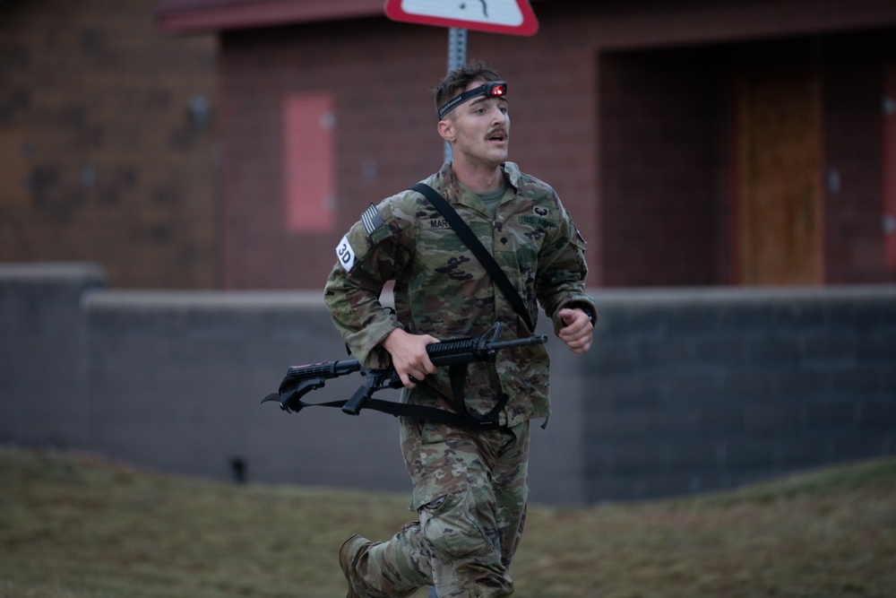 Sgt. Connor Housman runs with a weapon