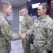 Commander presents coins to outgoing troops